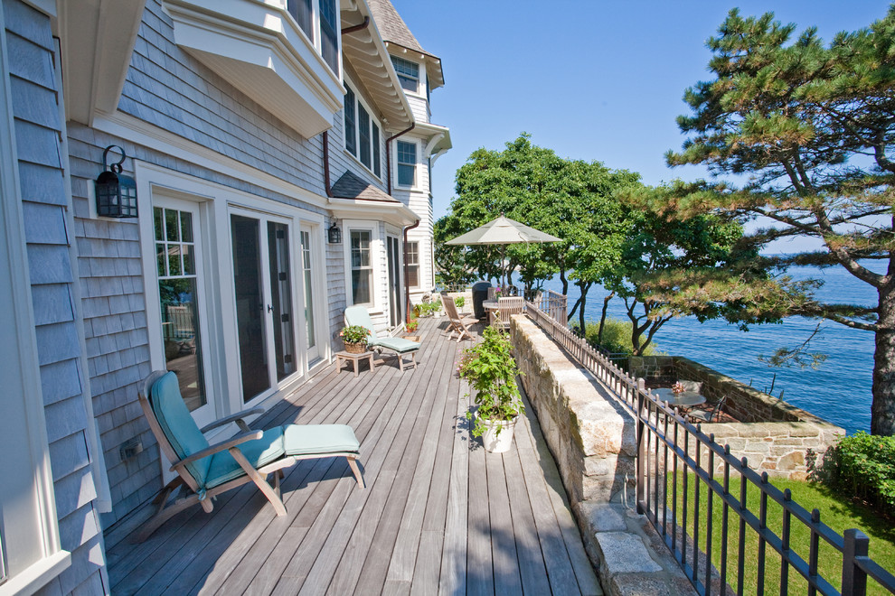This is an example of a beach style balcony in Boston with no cover.