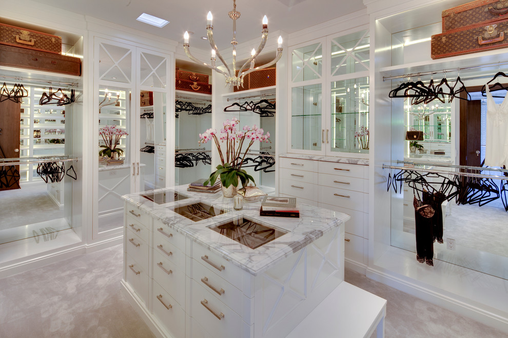 Design ideas for an expansive women's dressing room in Los Angeles with flat-panel cabinets, white cabinets and carpet.