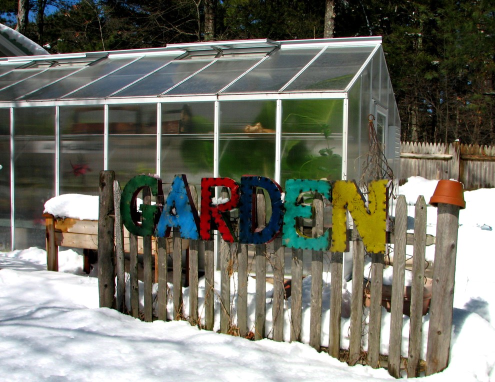 This is an example of an eclectic backyard garden for winter in Boston.