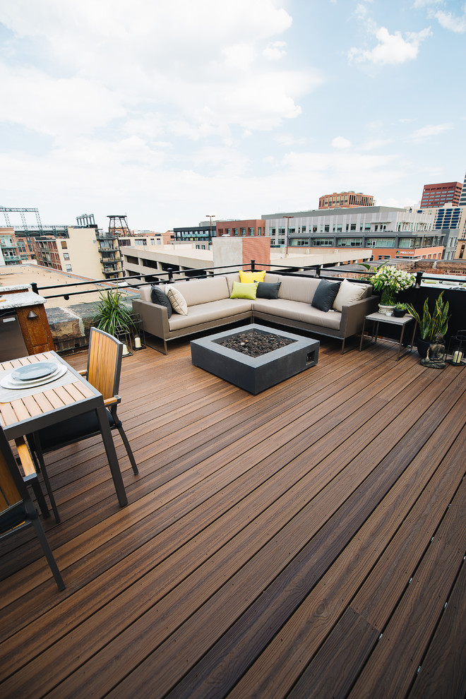 Photo of a mid-sized contemporary rooftop and rooftop deck in Other with a fire feature.