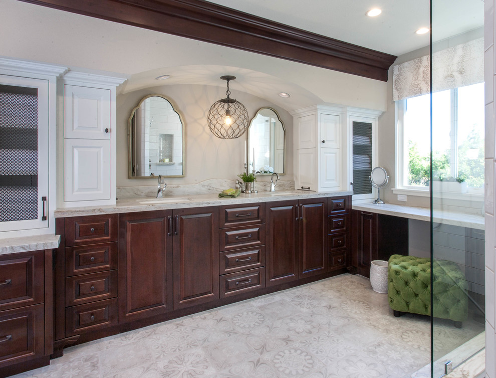 This is an example of a large mediterranean master bathroom in San Diego with white tile, ceramic tile, linoleum floors, an undermount sink, quartzite benchtops, grey floor, grey benchtops, raised-panel cabinets, dark wood cabinets and beige walls.