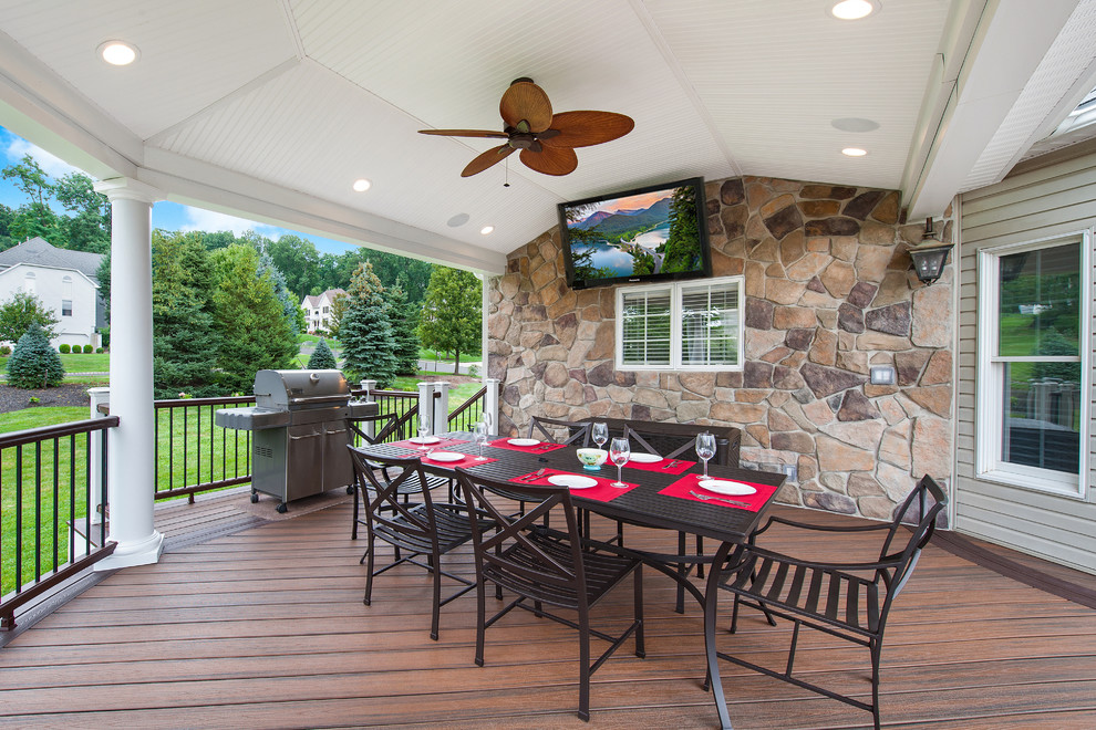 Inspiration for a traditional backyard deck in New York with a roof extension and an outdoor kitchen.