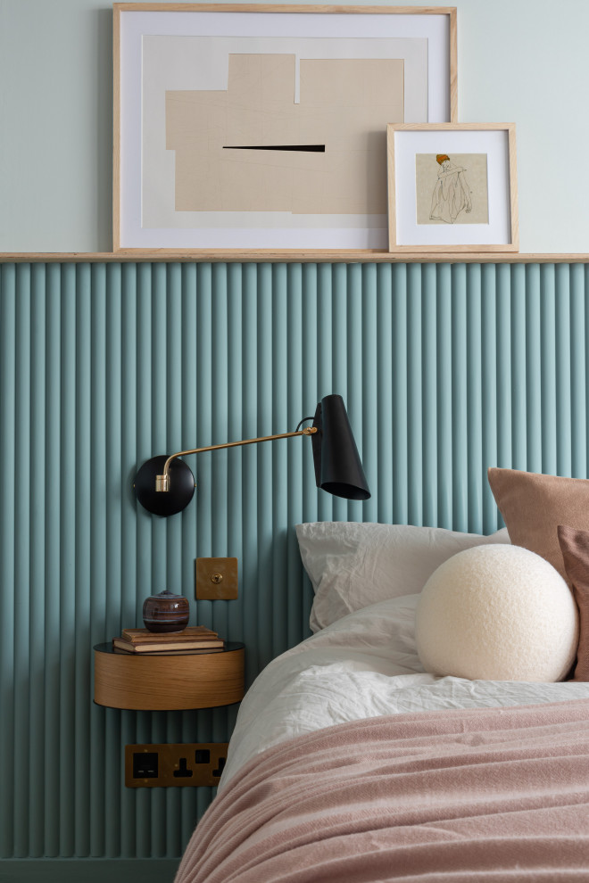 ロンドンにある小さなコンテンポラリースタイルのおしゃれな主寝室 (青い壁、カーペット敷き、標準型暖炉、タイルの暖炉まわり、黄色い床、パネル壁) のインテリア