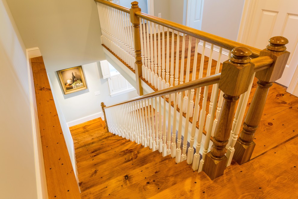 This is an example of a mid-sized traditional wood l-shaped staircase in Boston with painted wood risers.