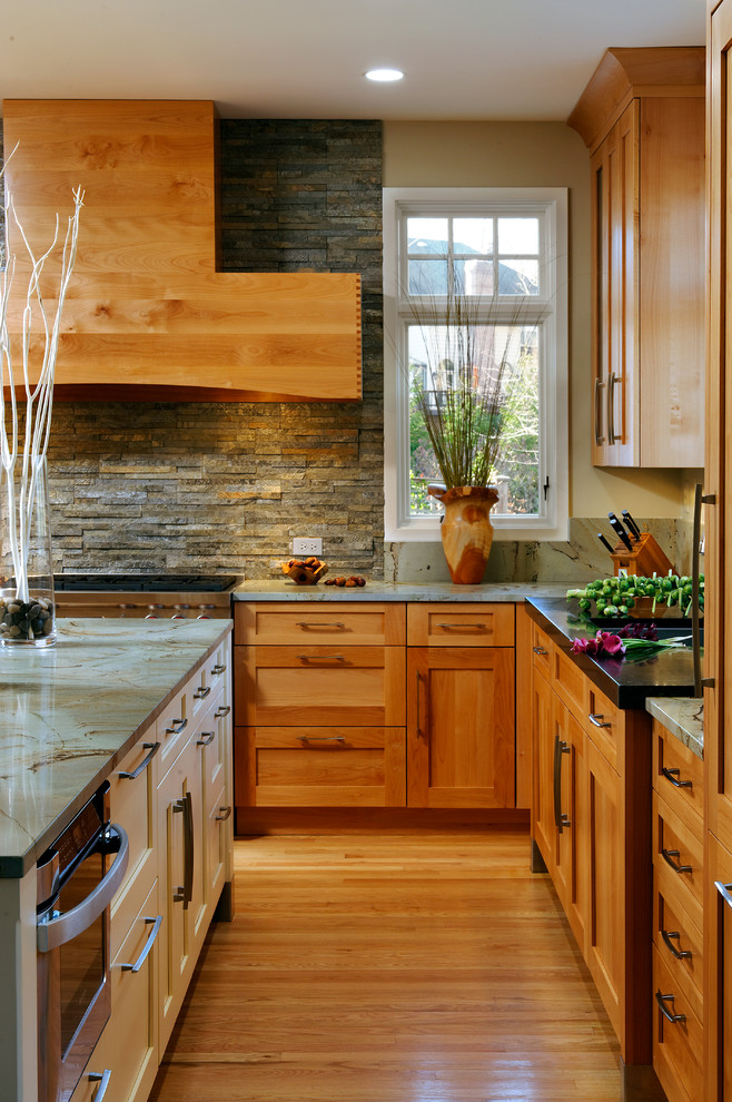 Inspiration for a mid-sized transitional l-shaped light wood floor and beige floor eat-in kitchen remodel in DC Metro with shaker cabinets, light wood cabinets, granite countertops, beige walls, an island, an undermount sink, gray backsplash, stone tile backsplash and stainless steel appliances