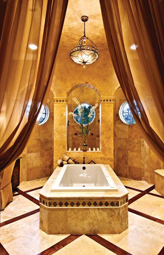 Inspiration for a large mediterranean master bathroom in Miami with an undermount sink, raised-panel cabinets, dark wood cabinets, granite benchtops, a drop-in tub, an open shower, a two-piece toilet, beige tile, ceramic tile, yellow walls and travertine floors.
