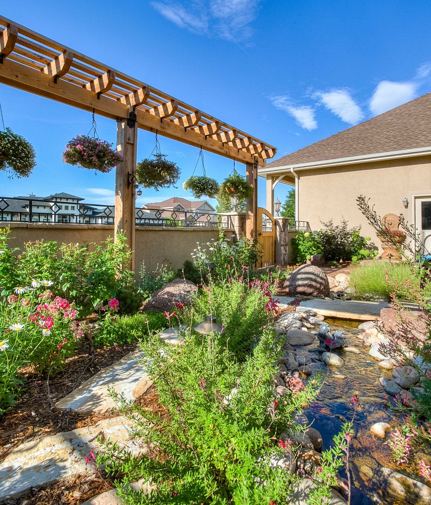This is an example of a mid-sized transitional partial sun front yard stone walkway in Denver.