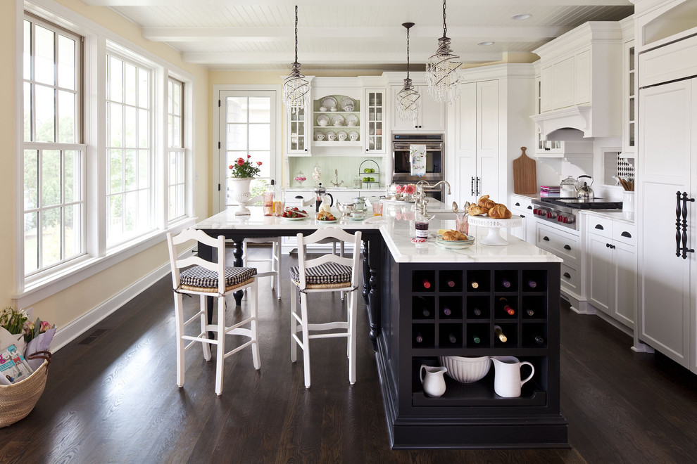 Design ideas for a mid-sized traditional kitchen in Minneapolis with shaker cabinets, white cabinets, white splashback, an undermount sink, marble benchtops, ceramic splashback, dark hardwood floors, with island and panelled appliances.