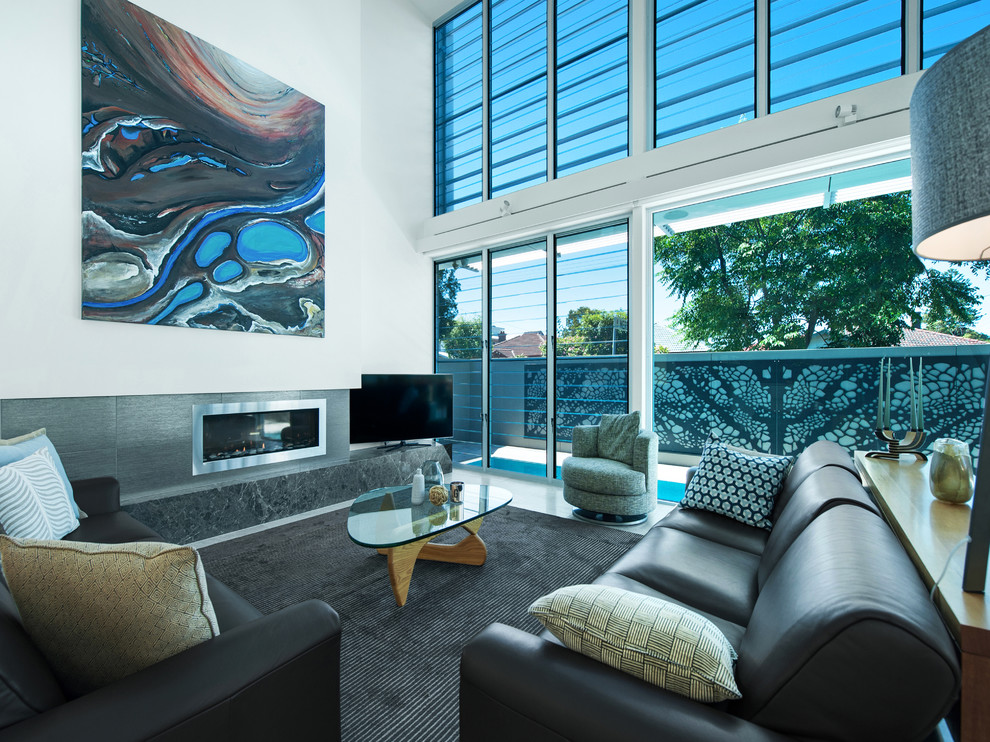 Inspiration for a contemporary open concept living room in Newcastle - Maitland with white walls, a ribbon fireplace, a stone fireplace surround and a freestanding tv.