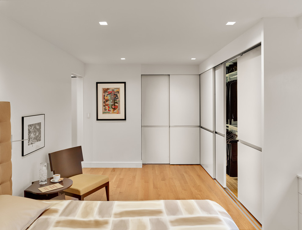 Inspiration for a large contemporary master bedroom in San Francisco with white walls and medium hardwood floors.