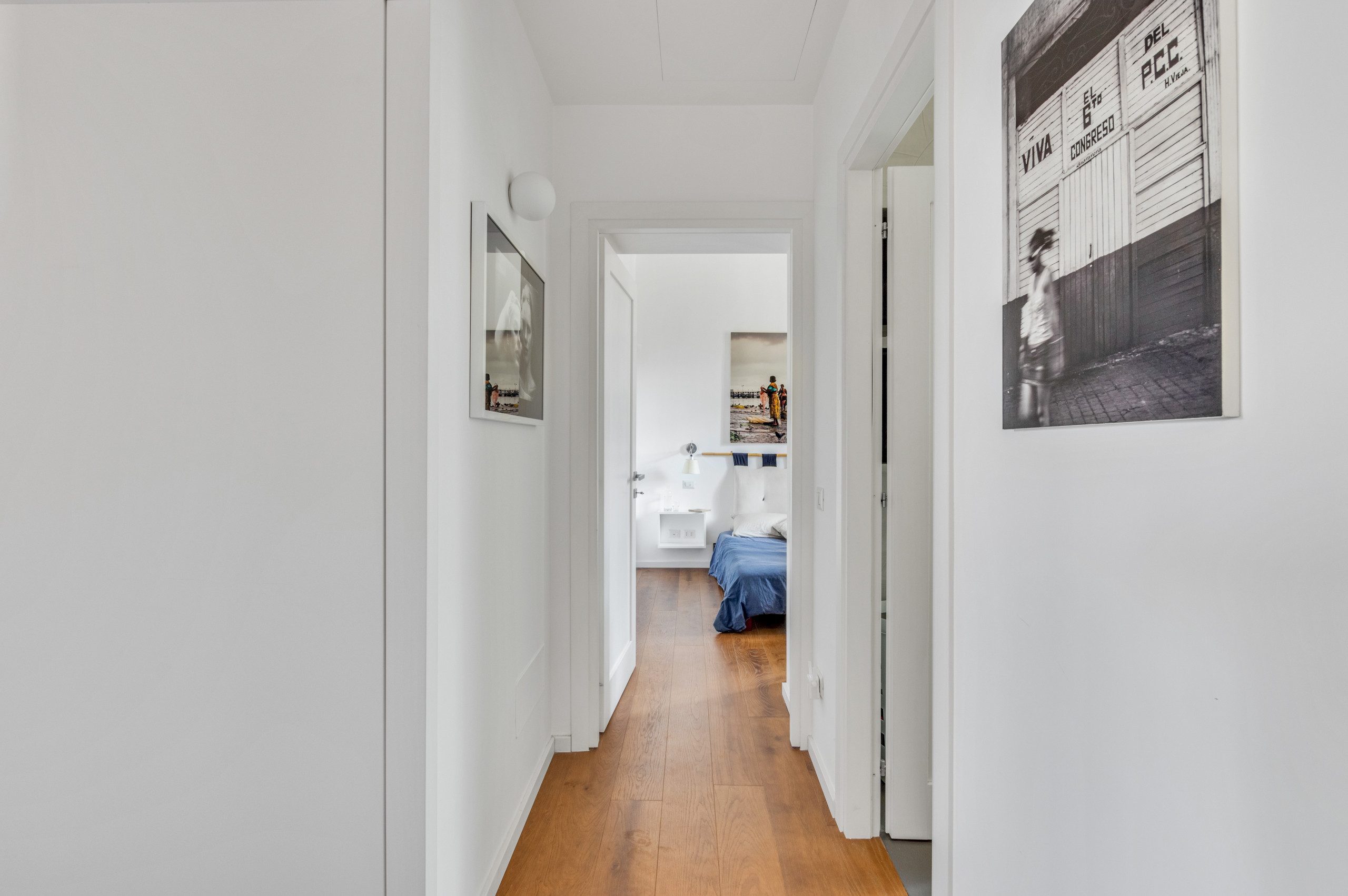 Mid-sized trendy dark wood floor hallway photo in Rome with white walls