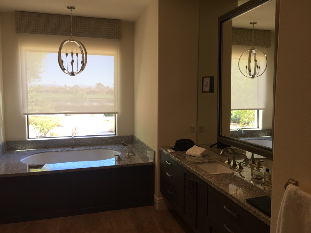 Example of a mid-sized transitional alcove bathtub design with shaker cabinets, black cabinets, a two-piece toilet, beige walls and an undermount sink