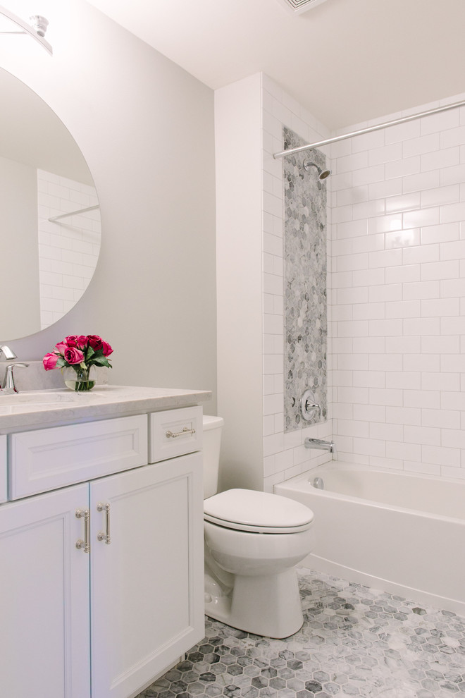 Mid-sized transitional master gray tile, white tile and stone tile marble floor alcove bathtub photo in Chicago with shaker cabinets, white cabinets, a two-piece toilet, gray walls and an undermount sink