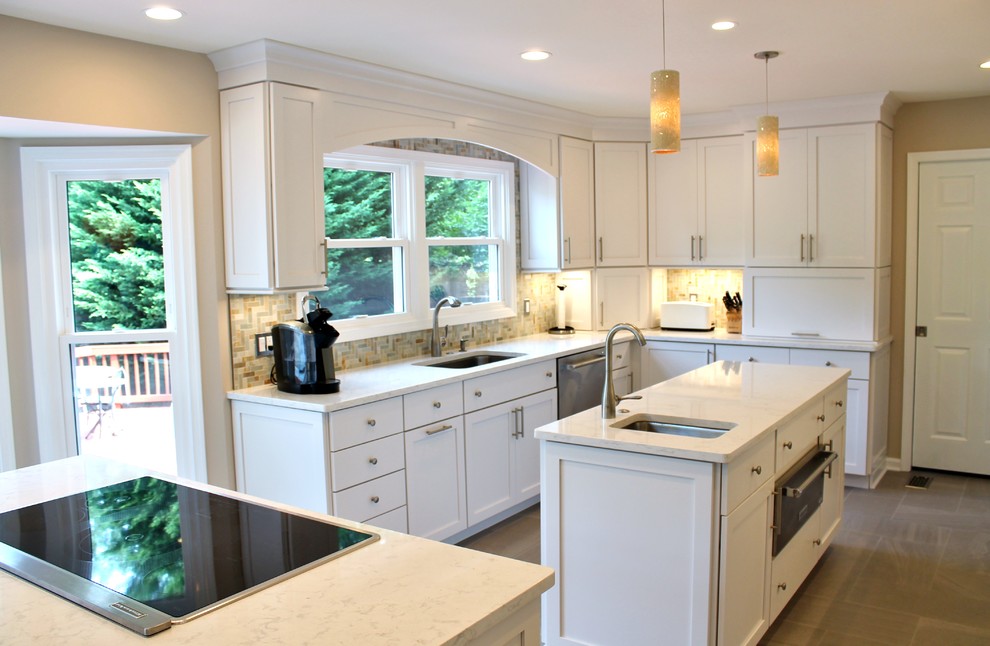 Inspiration for a large transitional porcelain tile and brown floor kitchen remodel in DC Metro with an undermount sink, white cabinets, beige backsplash, stainless steel appliances, two islands, shaker cabinets, quartzite countertops and stone tile backsplash