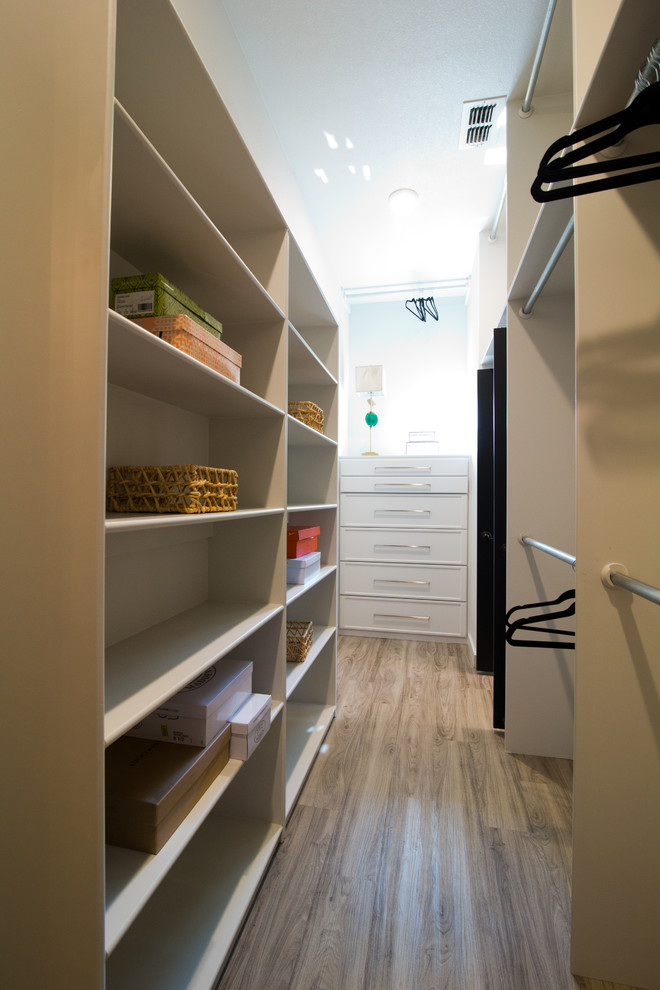 Inspiration for a large eclectic walk-in wardrobe in Austin with grey cabinets and vinyl floors.