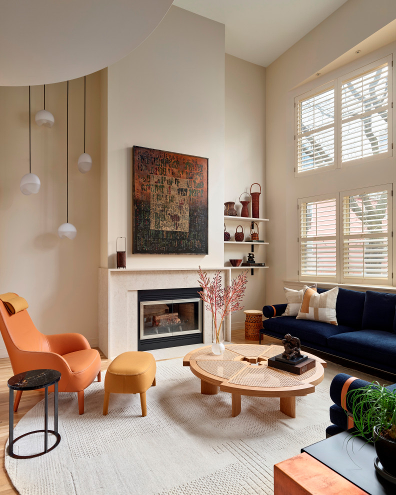 Living room - contemporary medium tone wood floor and beige floor living room idea in Philadelphia with beige walls and a standard fireplace
