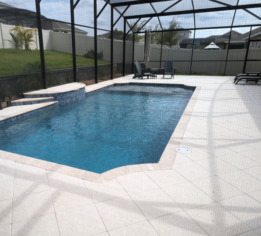 Example of a mid-sized backyard brick and custom-shaped lap pool design in Orlando