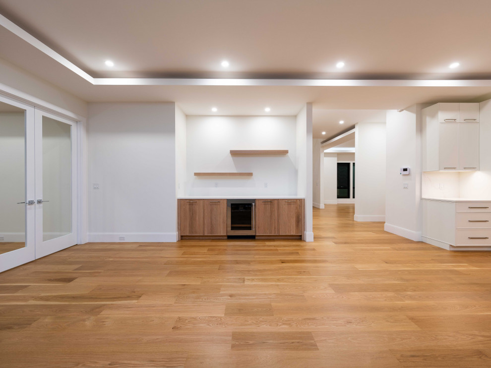 Inspiration for a transitional single-wall light wood floor dry bar remodel in Boston with shaker cabinets, light wood cabinets and quartz countertops