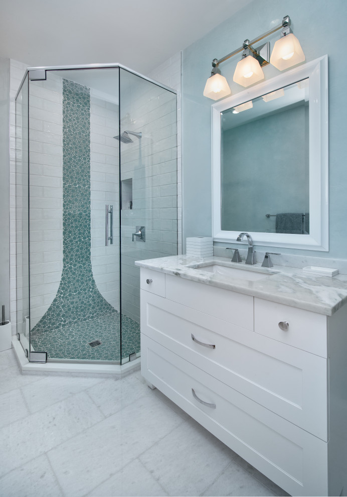 Corner shower - coastal white floor and single-sink corner shower idea in Miami with shaker cabinets, white cabinets, blue walls, an undermount sink, a hinged shower door, gray countertops, a niche and a freestanding vanity
