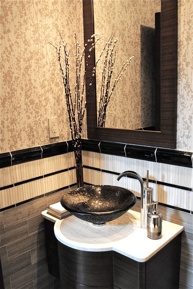 Design ideas for a contemporary powder room in New York with a vessel sink, a one-piece toilet, flat-panel cabinets, dark wood cabinets, limestone benchtops, beige tile and limestone.
