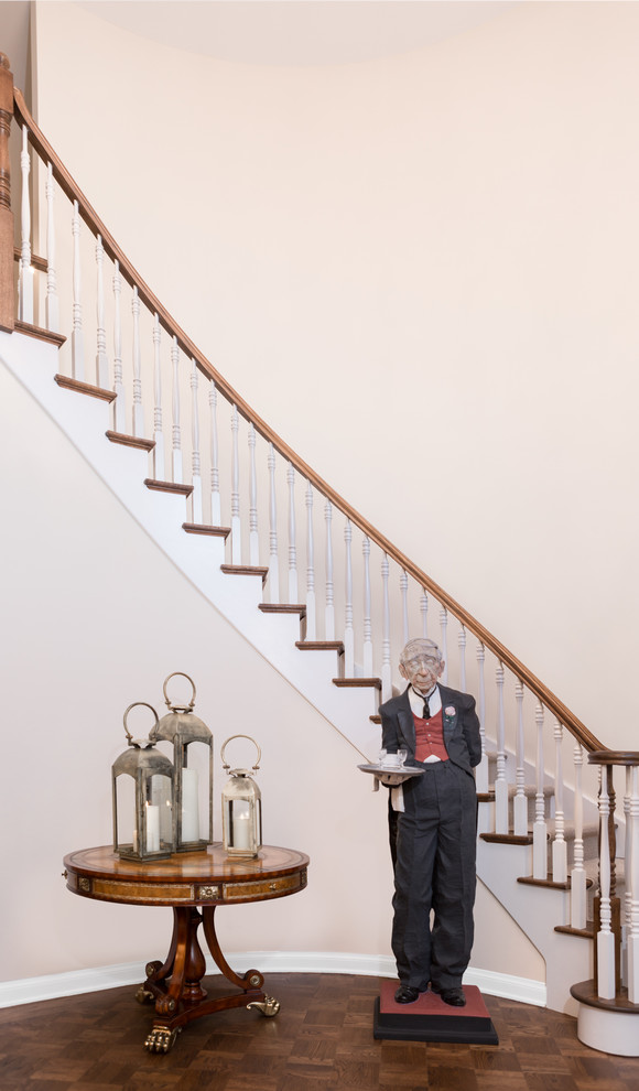 Inspiration for a large transitional carpeted curved wood railing staircase remodel in Chicago with carpeted risers