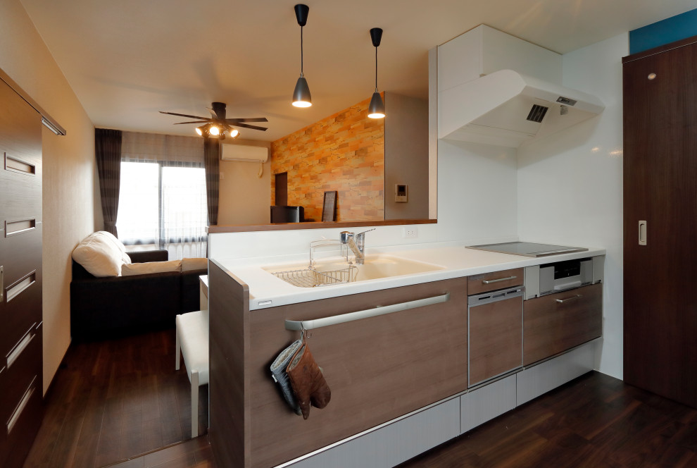 Photo of a large single-wall open plan kitchen in Other with an integrated sink, open cabinets, brown cabinets, solid surface benchtops, white splashback, glass sheet splashback, stainless steel appliances, vinyl floors, no island, brown floor, white benchtop and wallpaper.
