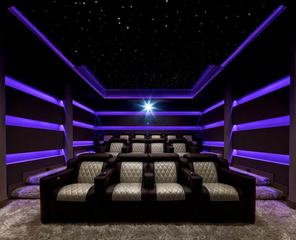 This is an example of a mid-sized modern enclosed home theatre in New York with purple walls, carpet, beige floor and a built-in media wall.