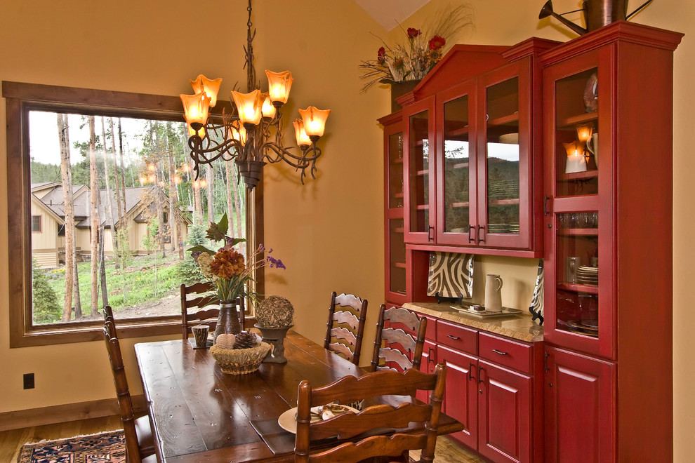 This is an example of a traditional dining room in Kansas City with yellow walls.
