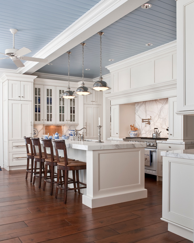 This is an example of a traditional kitchen in Indianapolis with recessed-panel cabinets, marble benchtops, white cabinets, white splashback, panelled appliances, marble splashback and white benchtop.