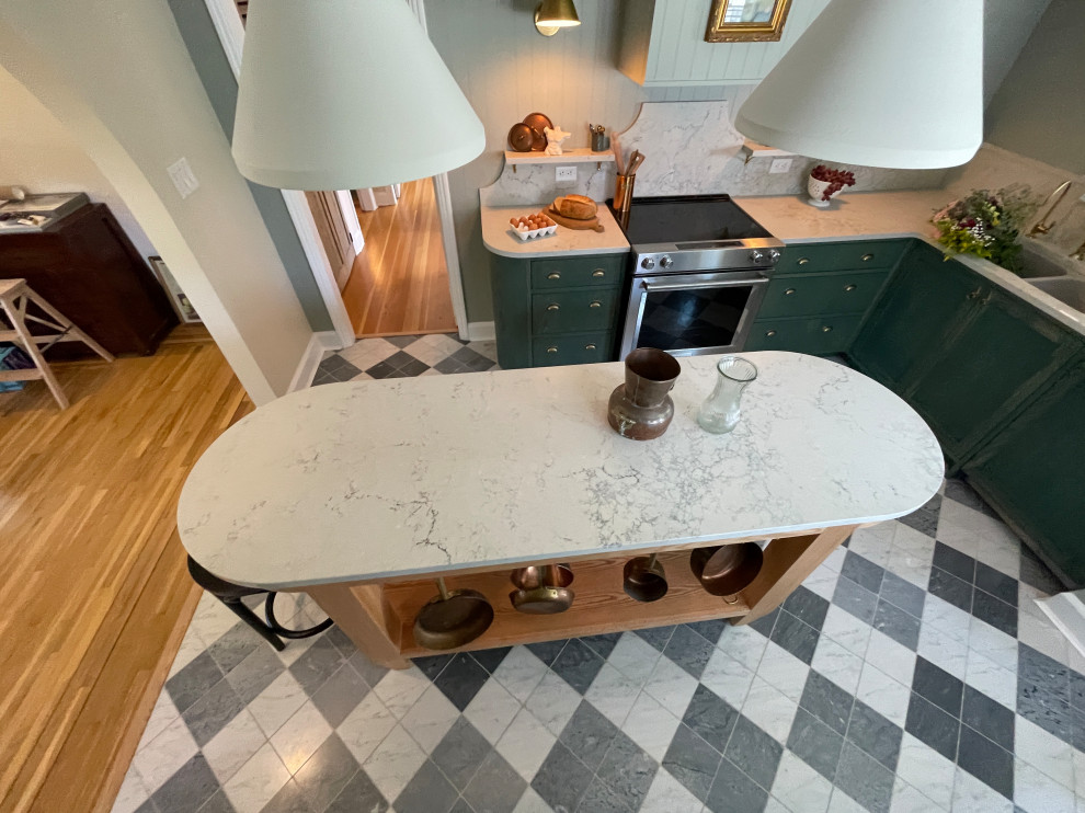 Example of a mid-sized transitional galley marble floor and multicolored floor open concept kitchen design with shaker cabinets, green cabinets, quartz countertops, white backsplash, quartz backsplash, stainless steel appliances, an island and white countertops