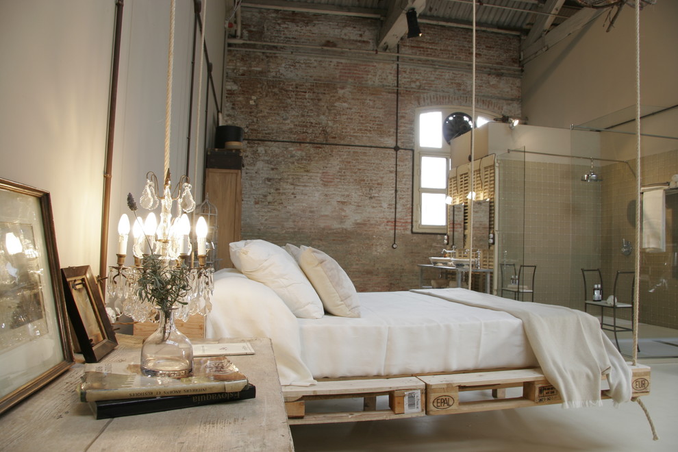 Inspiration for a large industrial master bedroom in Barcelona with beige walls and no fireplace.