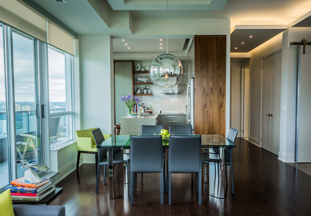 Photo of a mid-sized contemporary open plan dining in Toronto with white walls and dark hardwood floors.