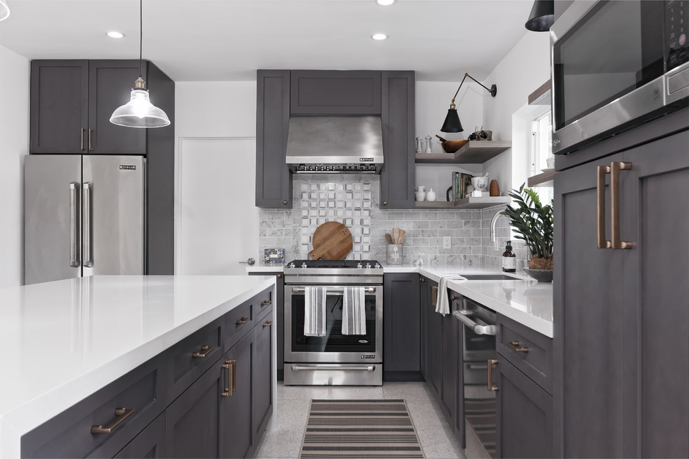 Design ideas for a large transitional kitchen in Miami with an undermount sink, shaker cabinets, grey cabinets, grey splashback, stainless steel appliances and grey floor.