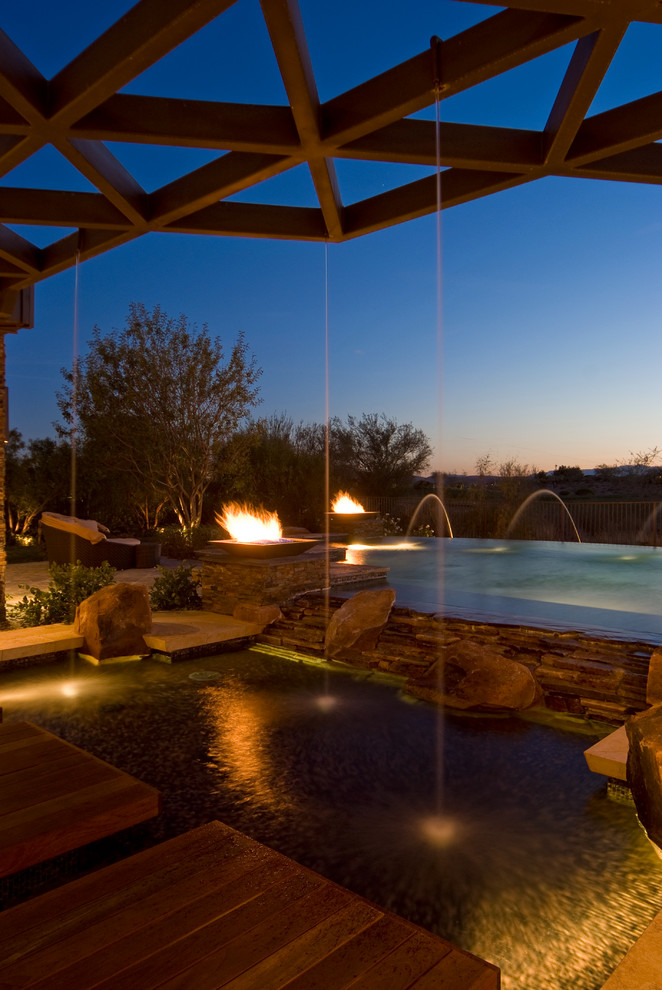 Inspiration for a contemporary rectangular pool in Las Vegas with a water feature.