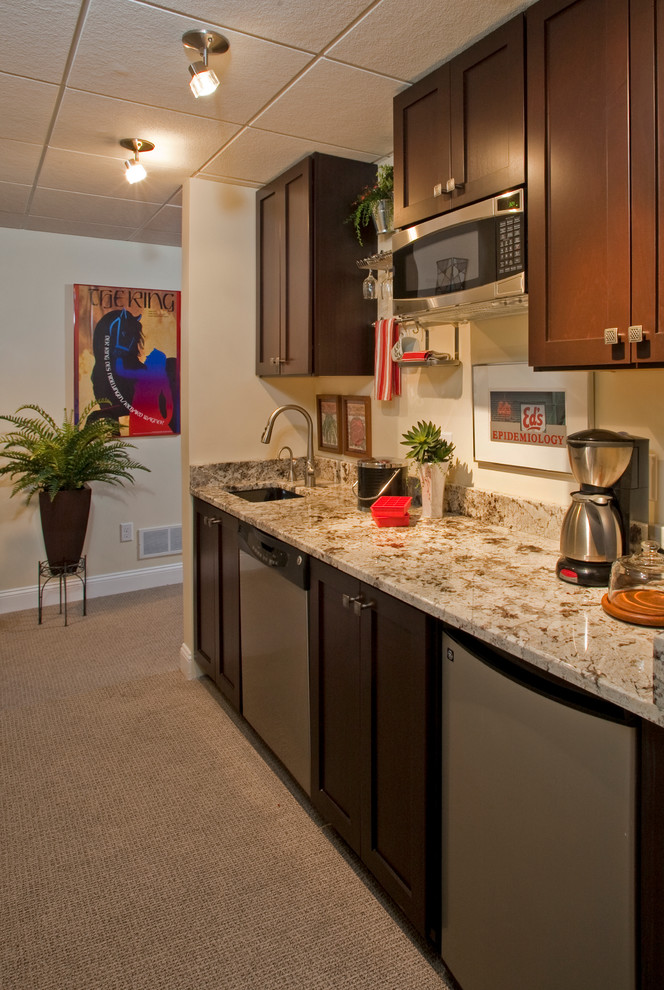 Small contemporary single-wall eat-in kitchen in Philadelphia with an undermount sink, shaker cabinets, dark wood cabinets, granite benchtops, beige splashback, stainless steel appliances, carpet and beige floor.