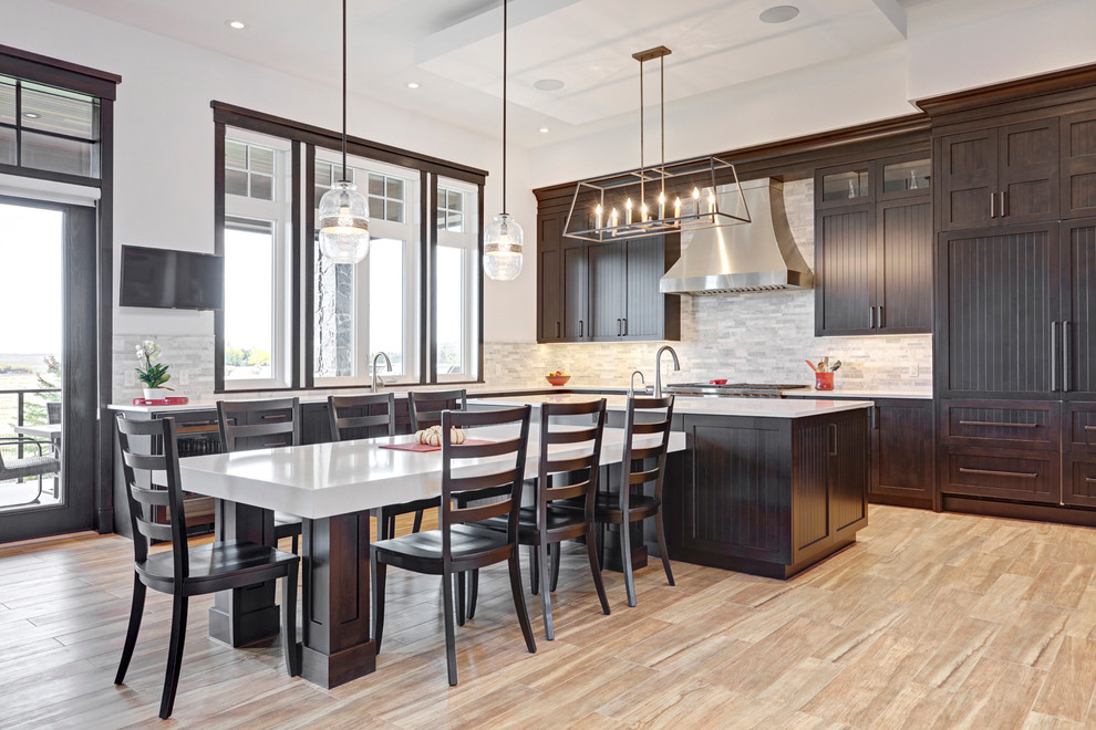 Kitchen - transitional porcelain tile kitchen idea in Calgary with an undermount sink, shaker cabinets, dark wood cabinets, quartzite countertops, multicolored backsplash, an island and paneled appliances