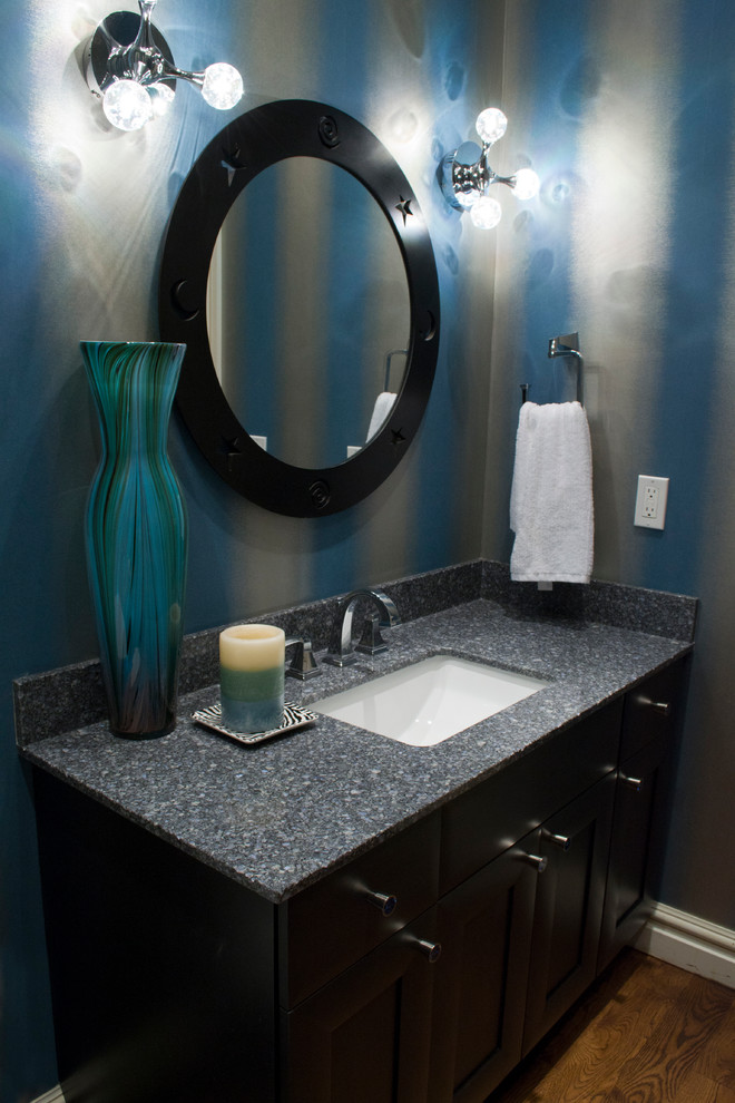 Inspiration for a small contemporary powder room in Oklahoma City with an undermount sink, recessed-panel cabinets, dark wood cabinets, engineered quartz benchtops, a two-piece toilet and medium hardwood floors.