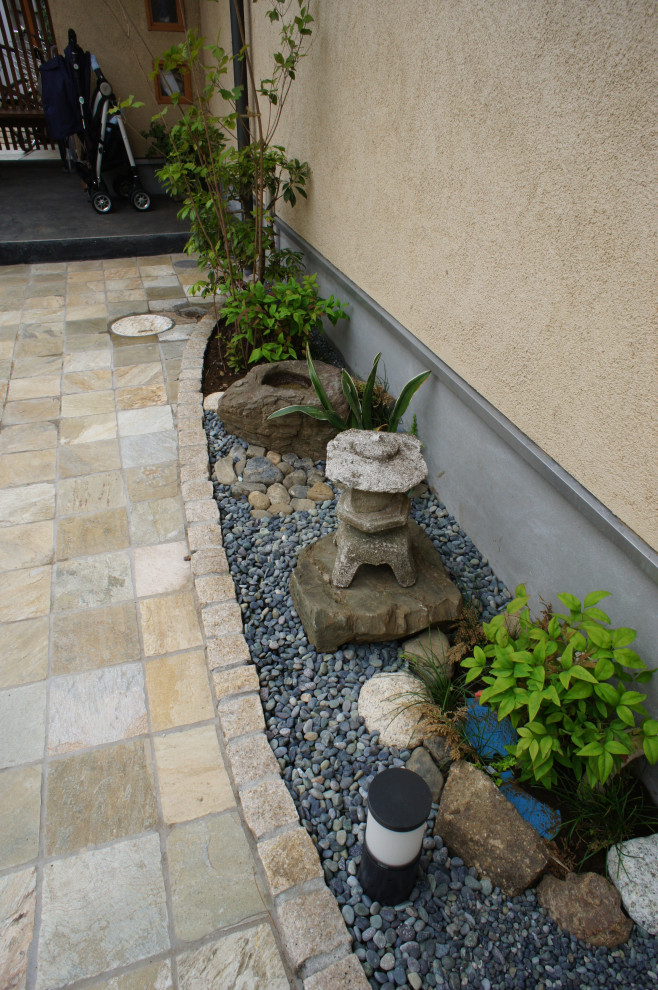 Photo of a mid-sized asian front yard verandah in Other with tile.
