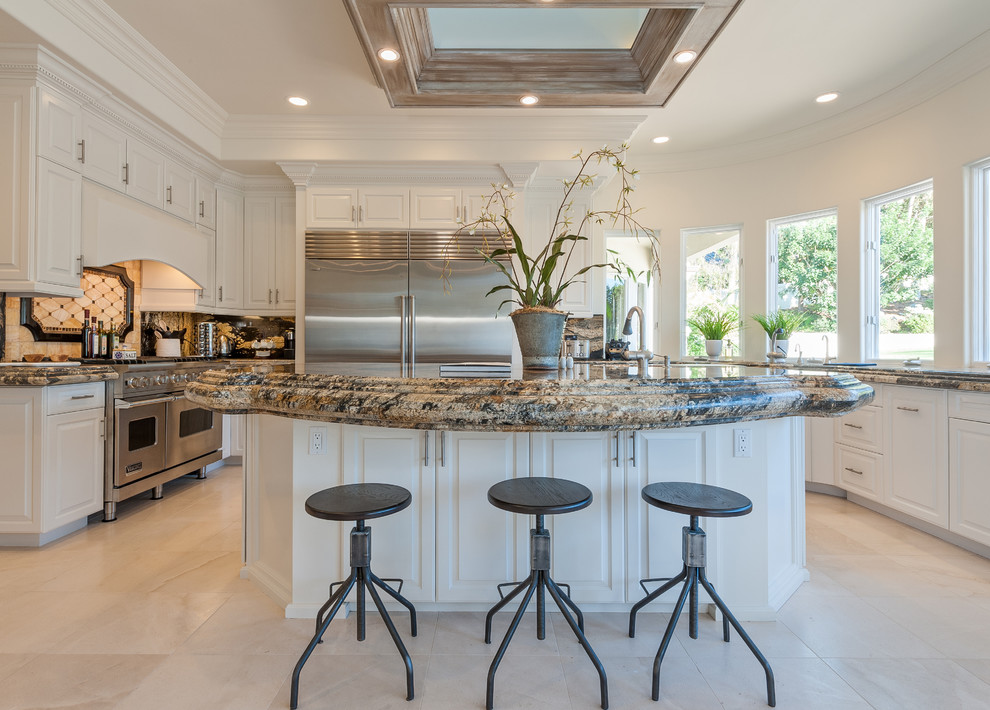 Design ideas for a classic u-shaped kitchen in San Diego with raised-panel cabinets, white cabinets, stainless steel appliances and an island.