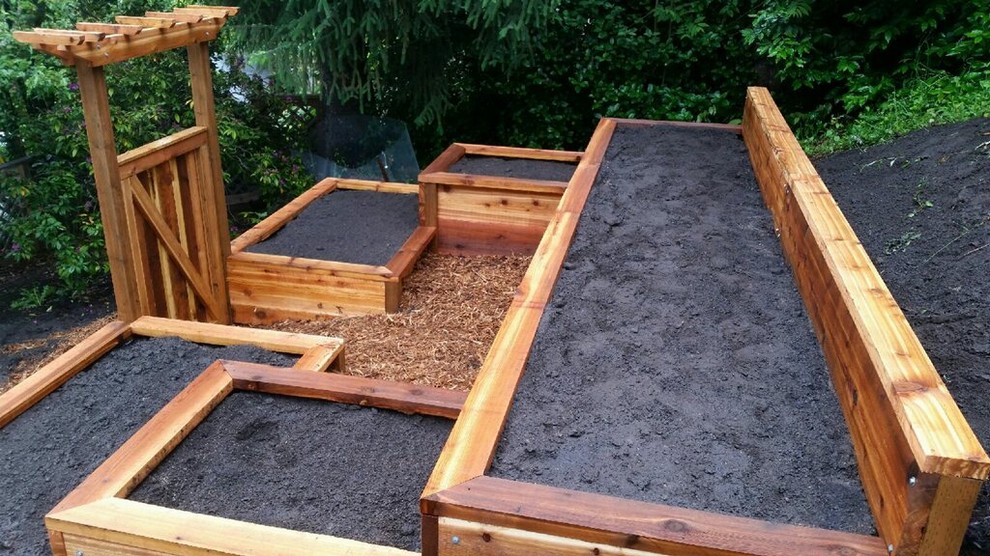 This is an example of a mid-sized arts and crafts sloped full sun garden for summer in Other with a vegetable garden and mulch.