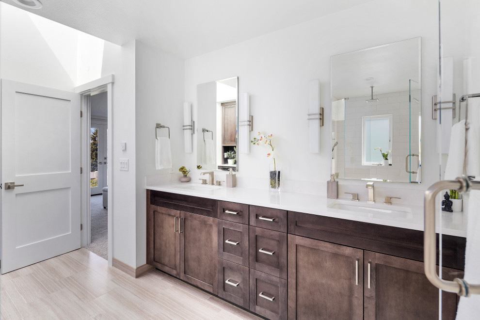 Photo of a large traditional ensuite bathroom in Seattle with shaker cabinets, dark wood cabinets, white tiles, light hardwood flooring, a submerged sink, engineered stone worktops, a hinged door, white worktops, a wall niche, double sinks and a built in vanity unit.