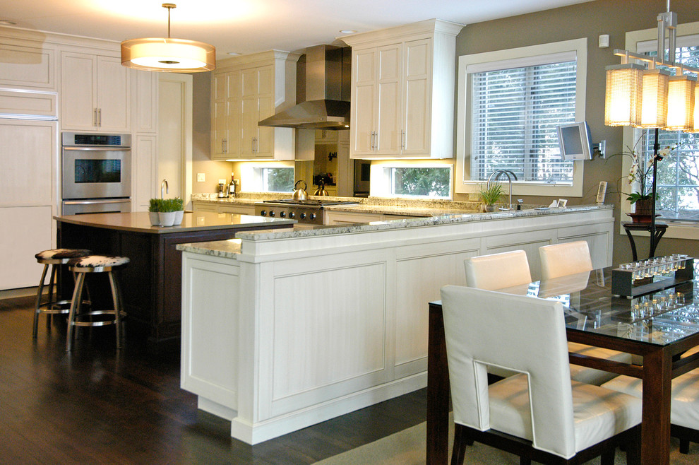 Eat-in kitchen - transitional eat-in kitchen idea in Chicago with flat-panel cabinets, white cabinets and stainless steel appliances