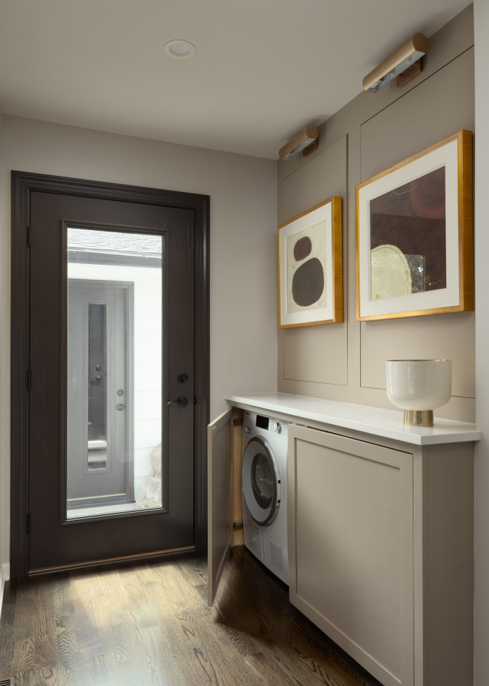 Design ideas for a small classic single-wall laundry cupboard in Other with shaker cabinets, grey cabinets, engineered stone countertops, dark hardwood flooring, a side by side washer and dryer and white worktops.