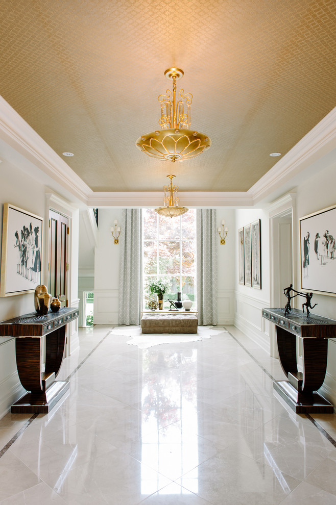 Inspiration for an expansive traditional hallway in Toronto with white walls and marble floors.
