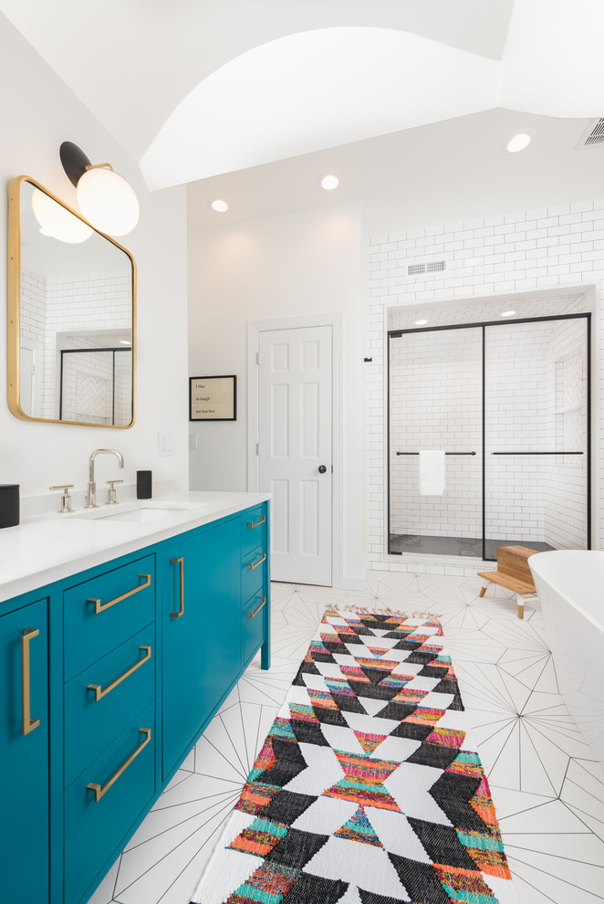 Photo of a large contemporary master bathroom in Chicago with flat-panel cabinets, a freestanding tub, white tile, subway tile, an undermount sink, engineered quartz benchtops, a hinged shower door, turquoise cabinets, an alcove shower, white walls, mosaic tile floors, white floor and white benchtops.