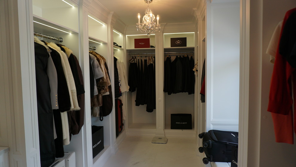Expansive transitional dressing room in Toronto with recessed-panel cabinets, white cabinets and marble floors.