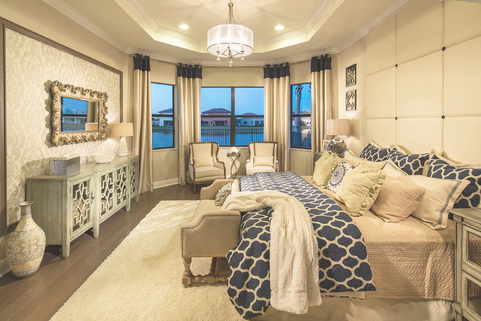 Inspiration for a large beach style master bedroom in Miami with beige walls, dark hardwood floors and brown floor.