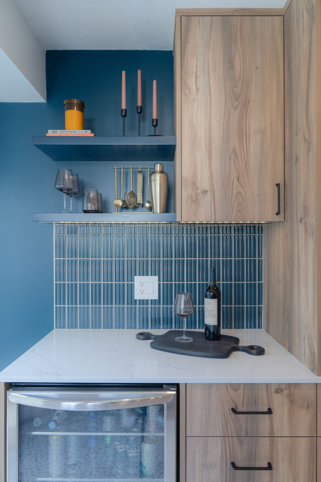 Inspiration for a small transitional u-shaped terrazzo floor and white floor eat-in kitchen remodel in Vancouver with a farmhouse sink, flat-panel cabinets, light wood cabinets, quartz countertops, blue backsplash, porcelain backsplash, stainless steel appliances, an island and white countertops