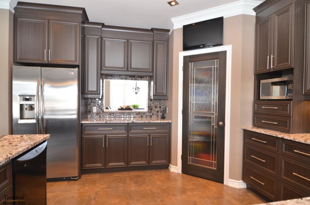 Inspiration for a large transitional u-shaped kitchen remodel in Ottawa with a double-bowl sink, recessed-panel cabinets, dark wood cabinets, granite countertops, multicolored backsplash, glass tile backsplash, stainless steel appliances and a peninsula