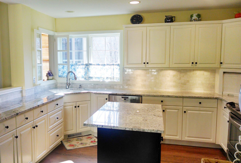 Mid-sized transitional u-shaped dark wood floor kitchen photo in Minneapolis with a double-bowl sink, raised-panel cabinets, white cabinets, granite countertops, white backsplash, ceramic backsplash, stainless steel appliances and an island